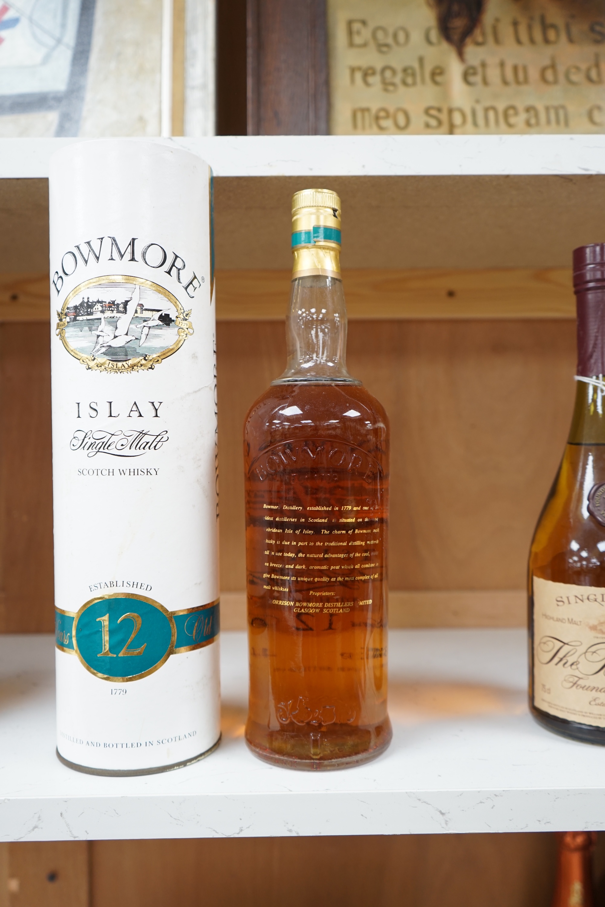 A bottle of Bowmore 12 Year Old Islay Single Malt Scotch Whisky, 1980s screen print bottle, 43% vol 1 litre, in original cardboard tube. Condition - good.